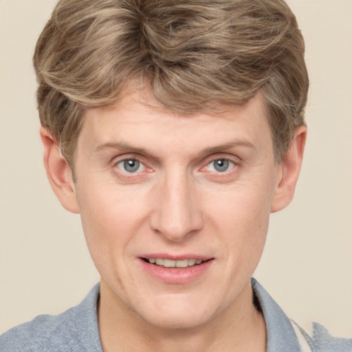 Joyful white adult male with short  brown hair and grey eyes