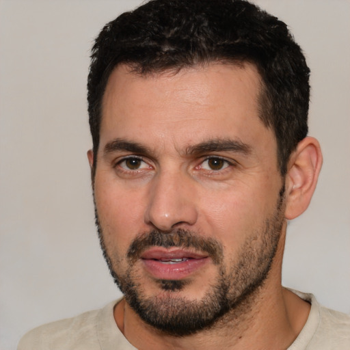 Joyful white young-adult male with short  black hair and brown eyes