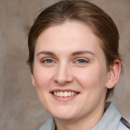 Joyful white young-adult female with medium  brown hair and grey eyes