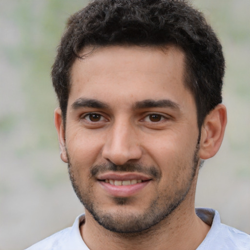 Joyful white young-adult male with short  black hair and brown eyes