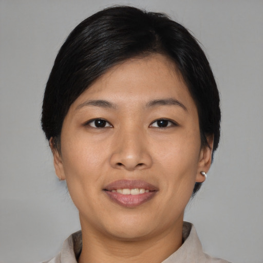 Joyful asian young-adult female with short  brown hair and brown eyes