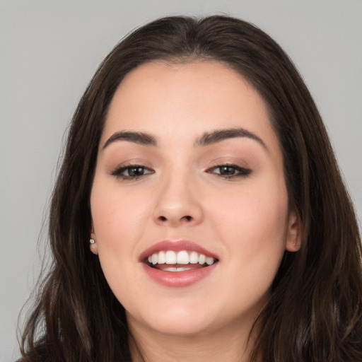 Joyful white young-adult female with long  brown hair and brown eyes