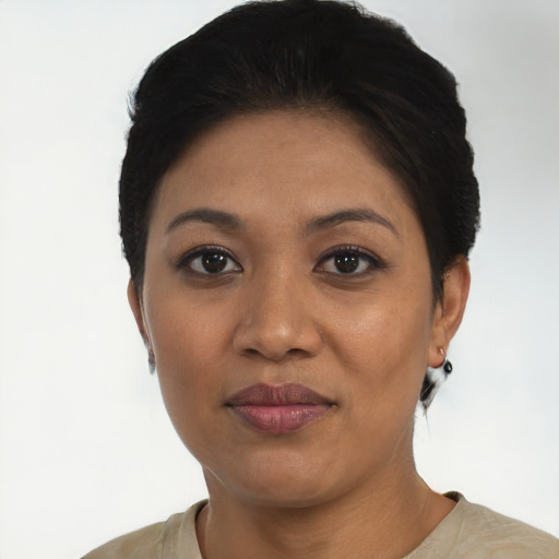 Joyful latino young-adult female with short  black hair and brown eyes