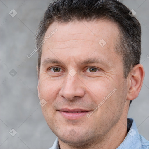 Joyful white adult male with short  brown hair and brown eyes