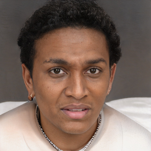Joyful black adult female with short  brown hair and brown eyes