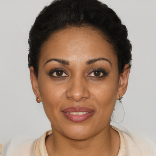 Joyful latino young-adult female with short  black hair and brown eyes