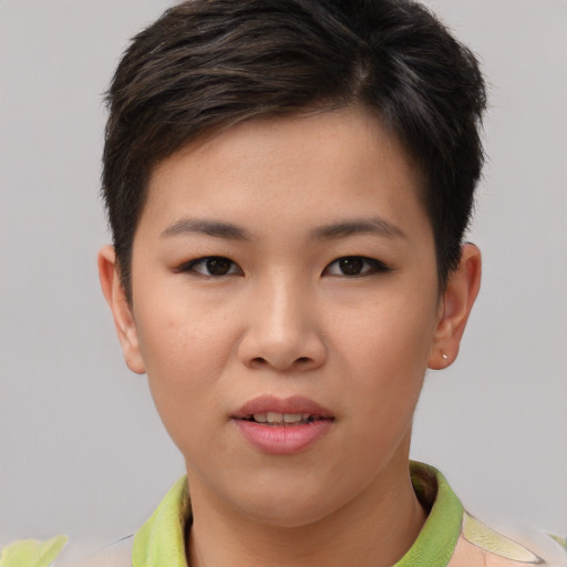 Joyful asian young-adult female with short  brown hair and brown eyes