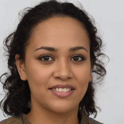 Joyful latino young-adult female with long  brown hair and brown eyes