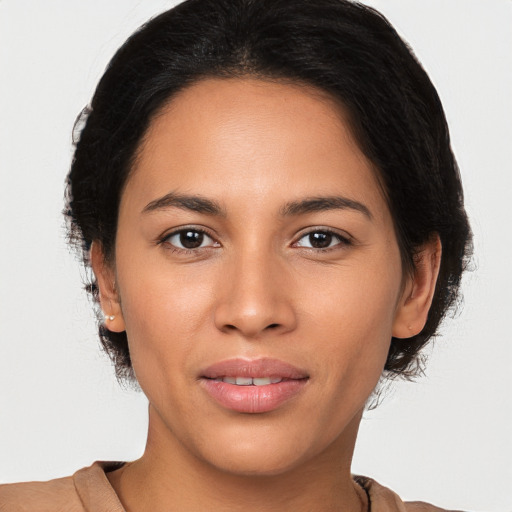 Joyful latino young-adult female with medium  brown hair and brown eyes