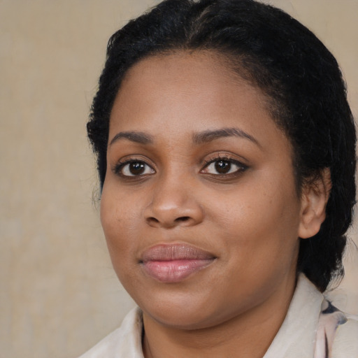 Joyful black young-adult female with medium  brown hair and brown eyes