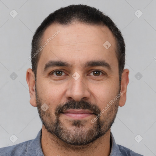 Joyful white adult male with short  black hair and brown eyes