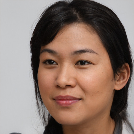 Joyful asian young-adult female with medium  black hair and brown eyes
