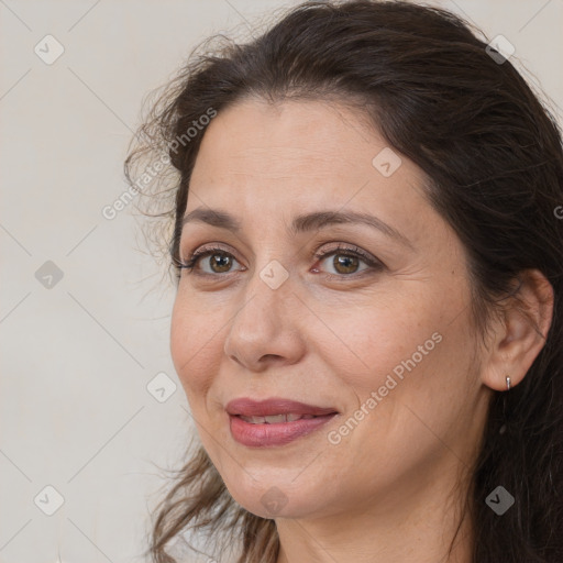 Joyful white adult female with long  brown hair and brown eyes