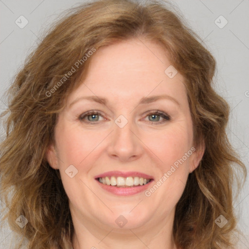 Joyful white adult female with long  brown hair and brown eyes