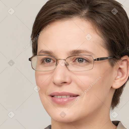 Joyful white adult female with medium  brown hair and grey eyes