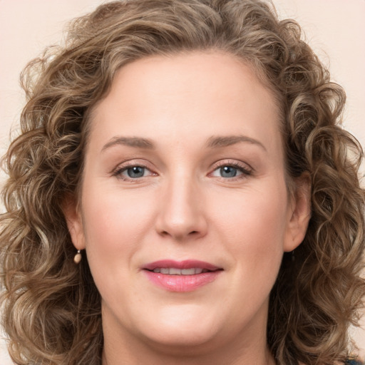 Joyful white young-adult female with long  brown hair and green eyes