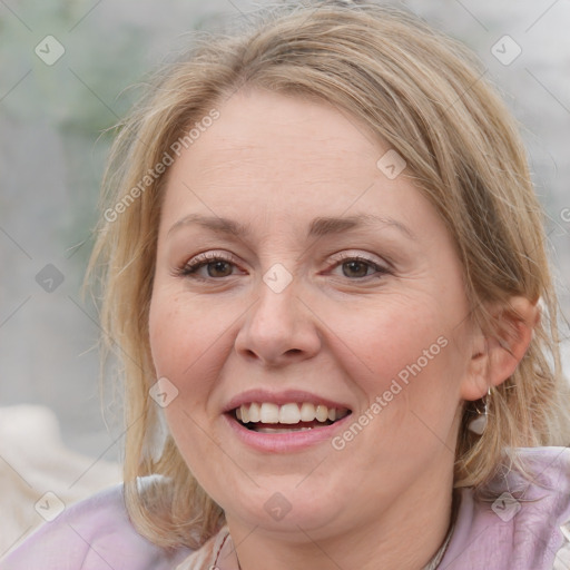 Joyful white adult female with medium  brown hair and blue eyes