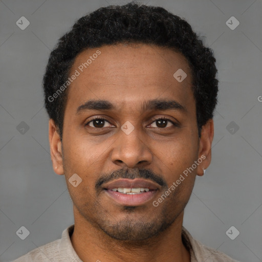 Joyful black young-adult male with short  brown hair and brown eyes