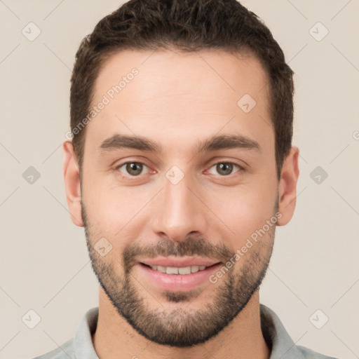 Joyful white young-adult male with short  brown hair and brown eyes