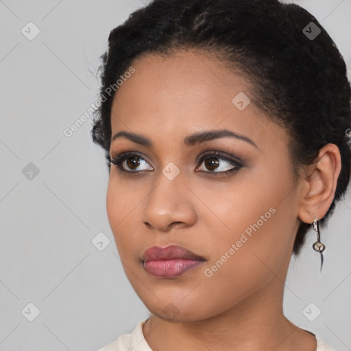 Joyful black young-adult female with medium  black hair and brown eyes