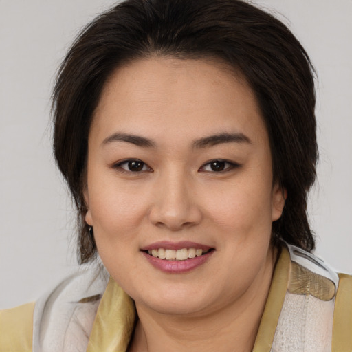 Joyful white young-adult female with medium  brown hair and brown eyes