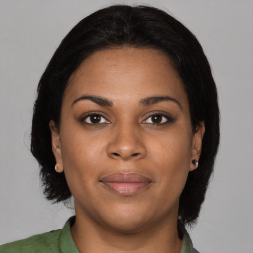 Joyful black young-adult female with medium  black hair and brown eyes