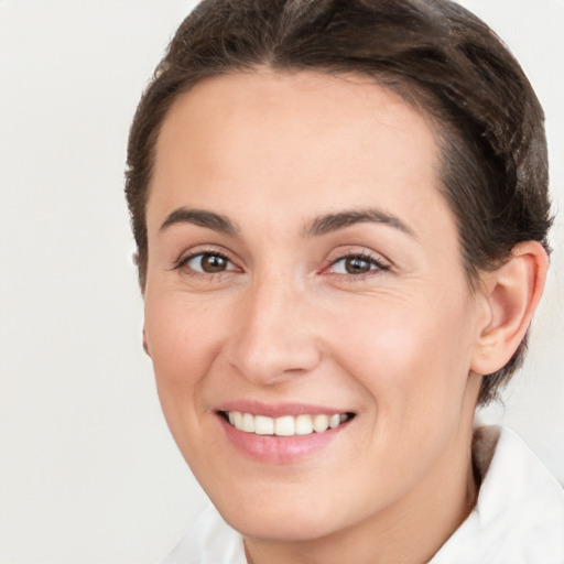 Joyful white young-adult female with medium  brown hair and brown eyes