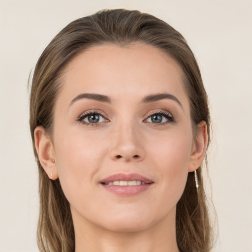 Joyful white young-adult female with long  brown hair and grey eyes