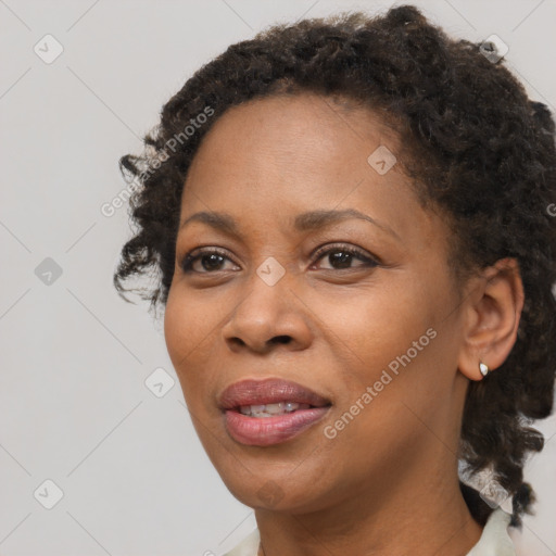 Joyful black adult female with short  brown hair and brown eyes