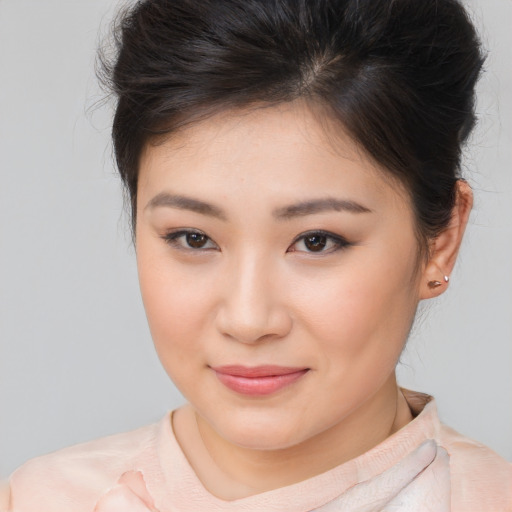 Joyful asian young-adult female with short  brown hair and brown eyes