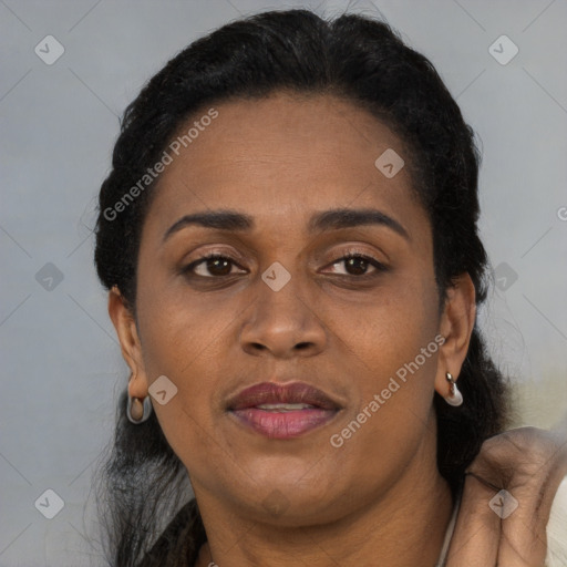 Joyful black adult female with short  black hair and brown eyes