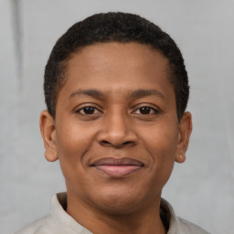 Joyful latino young-adult male with short  brown hair and brown eyes