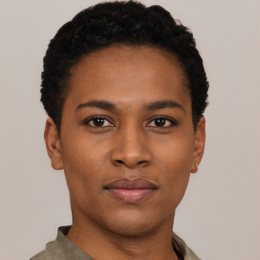 Joyful black young-adult female with short  black hair and brown eyes
