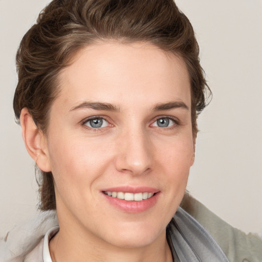 Joyful white young-adult female with medium  brown hair and grey eyes