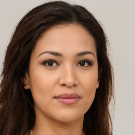 Joyful latino young-adult female with long  brown hair and brown eyes