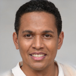 Joyful latino young-adult male with short  brown hair and brown eyes