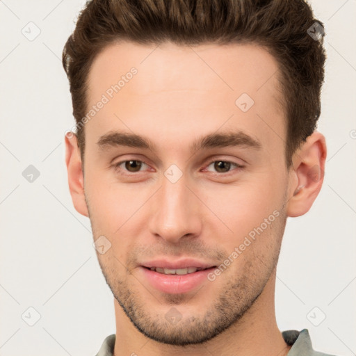 Joyful white young-adult male with short  brown hair and brown eyes