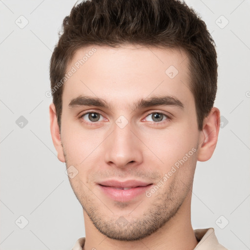 Joyful white young-adult male with short  brown hair and brown eyes