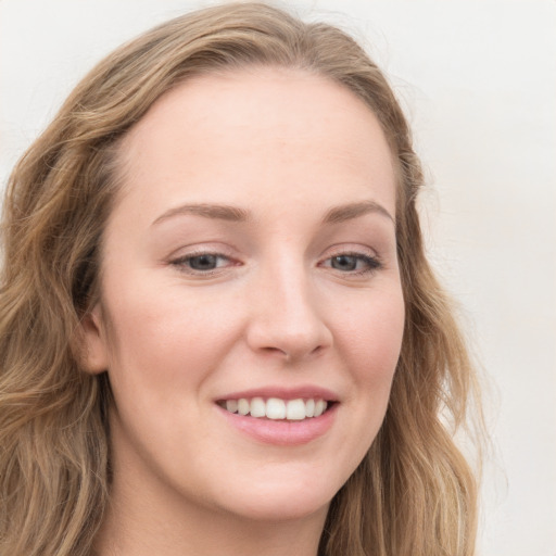 Joyful white young-adult female with long  brown hair and blue eyes