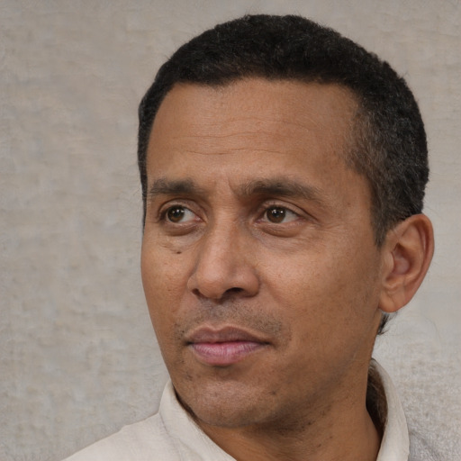 Neutral latino adult male with short  black hair and brown eyes