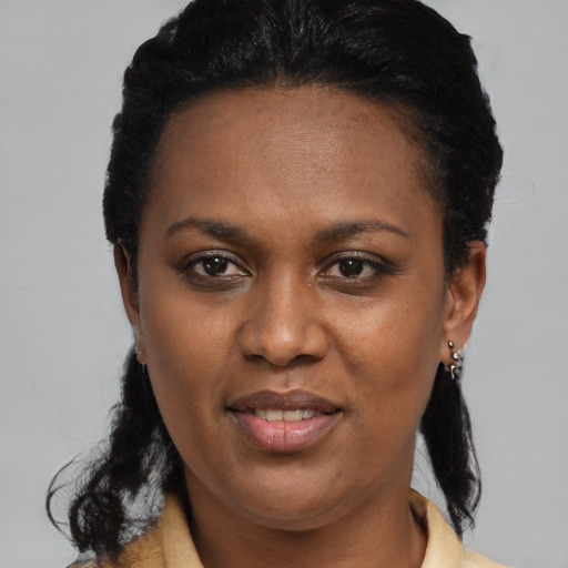 Joyful black young-adult female with medium  black hair and brown eyes