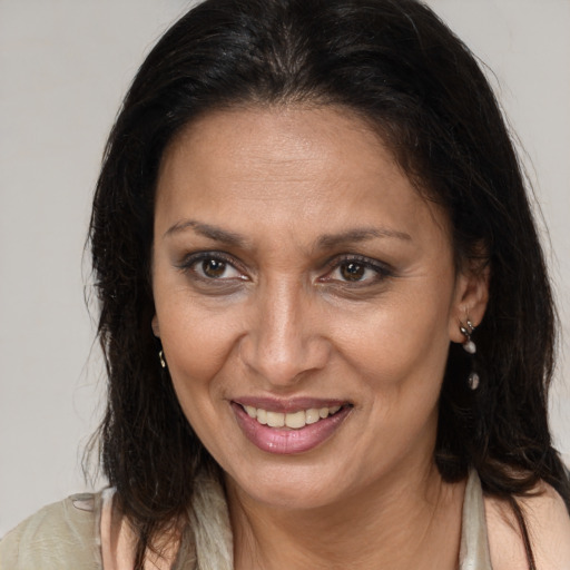 Joyful latino adult female with long  brown hair and brown eyes