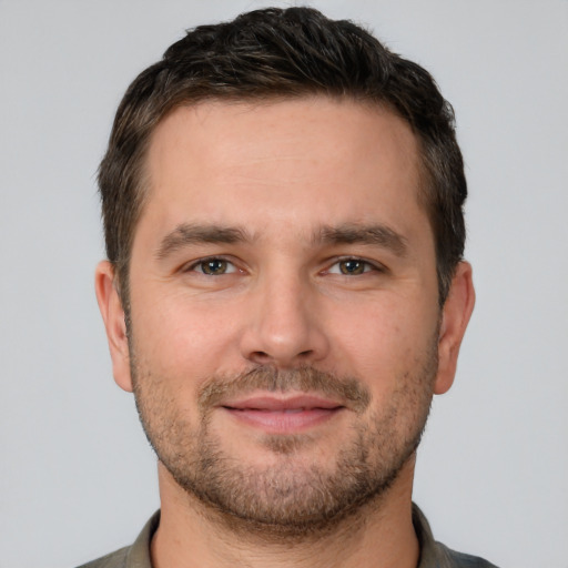 Joyful white adult male with short  brown hair and brown eyes