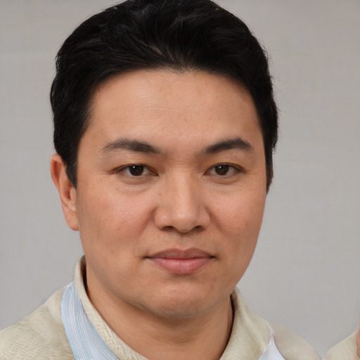 Joyful white young-adult male with short  black hair and brown eyes