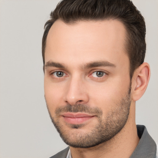 Joyful white young-adult male with short  brown hair and brown eyes