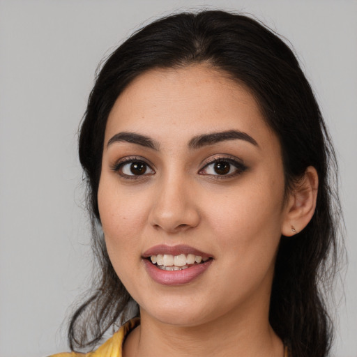 Joyful white young-adult female with long  black hair and brown eyes