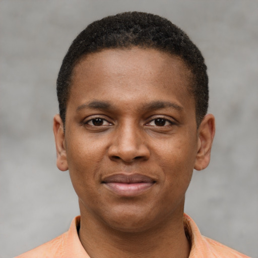 Joyful black young-adult male with short  brown hair and brown eyes