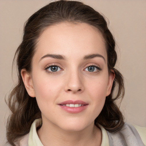 Joyful white young-adult female with medium  brown hair and grey eyes