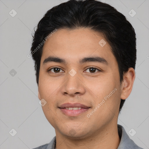 Joyful white young-adult male with short  black hair and brown eyes