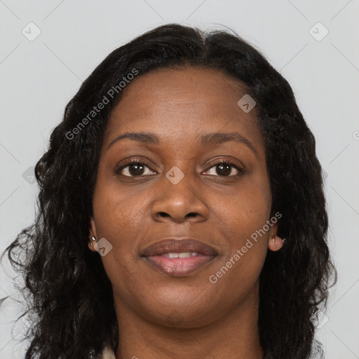 Joyful black adult female with long  brown hair and brown eyes